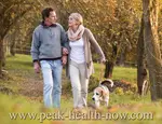 Couple with beagle in woods